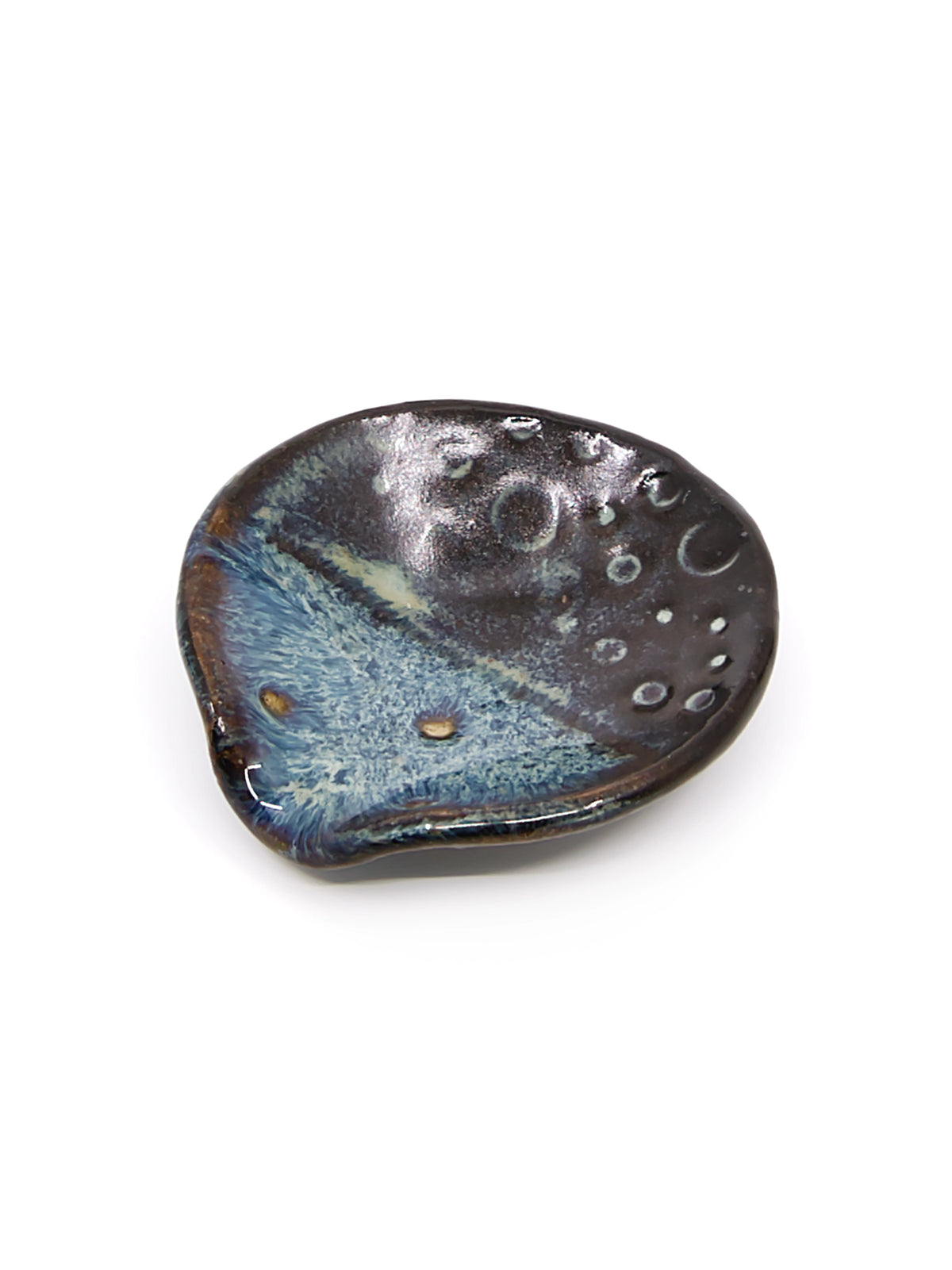 A small organic shaped round ceramic teaspoon or trinket dish with stormy dark brown and blue design