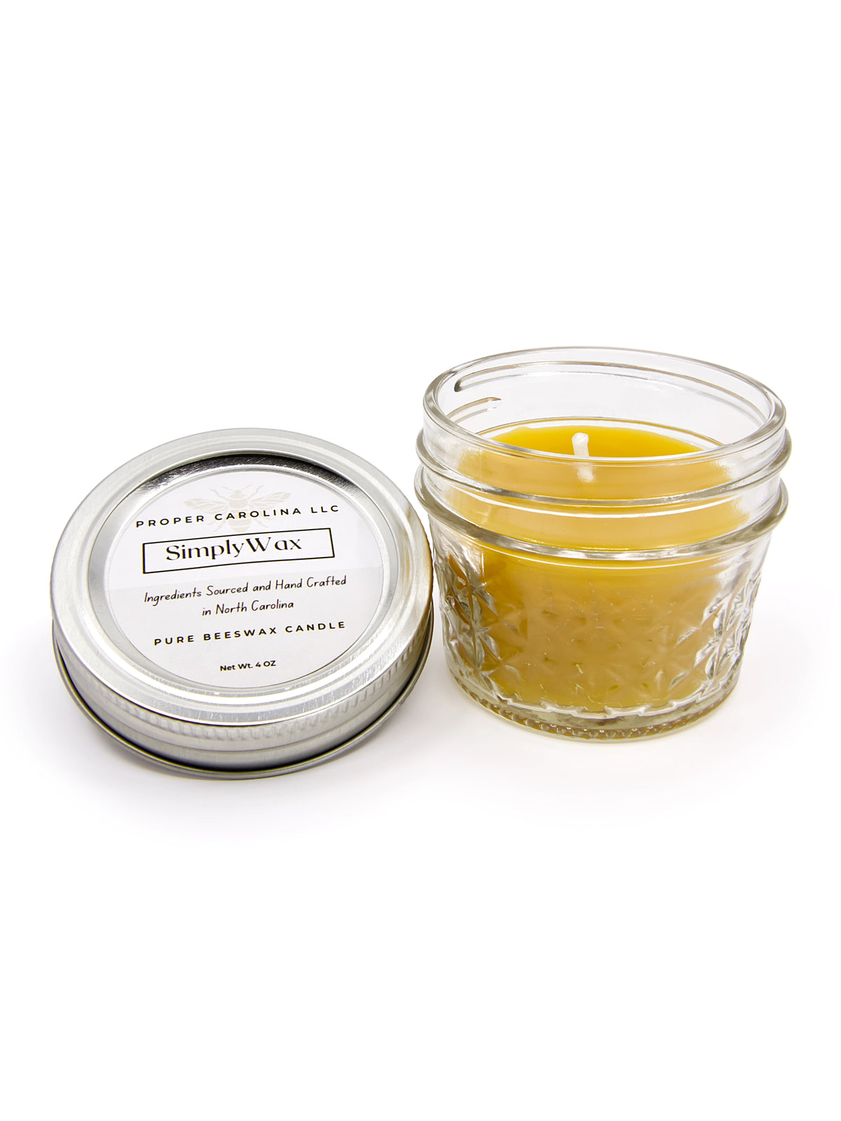 A beeswax candle with a cotton wick in a ceramix jar with the lid on the side with the words SimplyWax handcrafted in North Carolina by Proper Carolina LLC on a white background